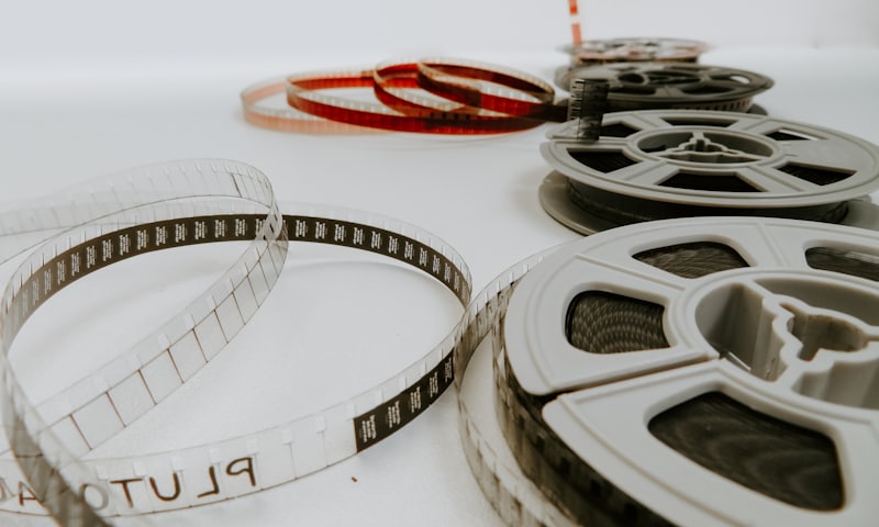 Film reels and unwound film strips laid out on a surface — video and photo production studio case study